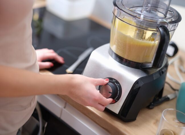 Kobieta w kuchni używa malaksera z ustawieniem trybu pracy